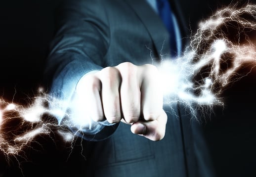 Close up of businessman hand holding lightning in fist